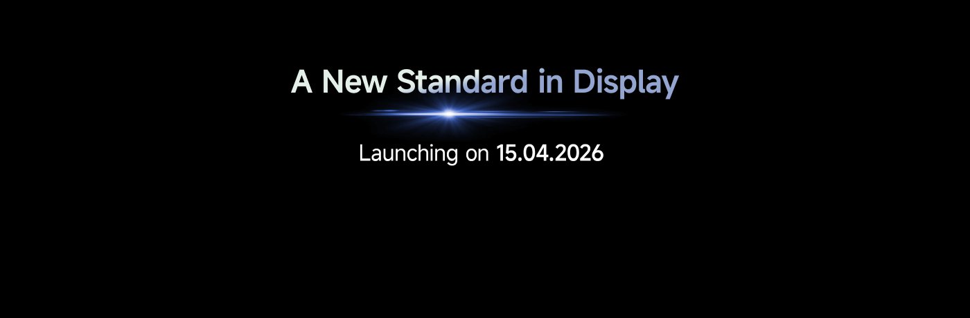 A promotional image announcing "A New Standard in Display," with a launch date of 15.04.2026. The background is black with a subtle light effect, emphasizing the text.