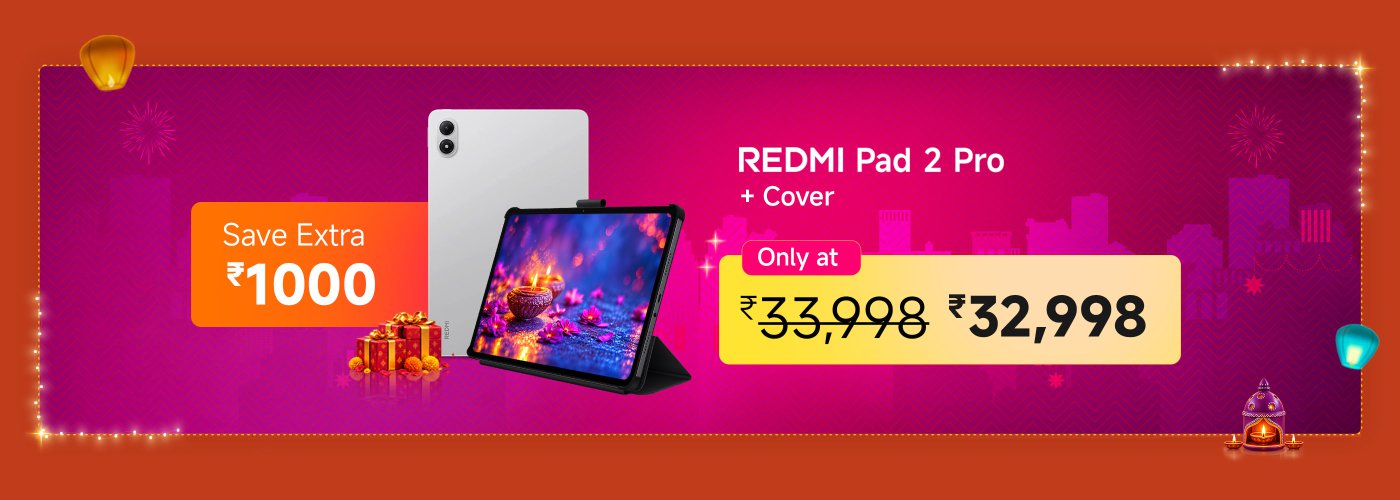 The advertisement promotes the REDMI Pad 2 Pro, which includes a cover, with a price reduction. The original price is ₹33,998, but it is now available for ₹32,998, offering an additional saving of ₹1,000. The background features festive elements like fireworks and decorations, suggesting a celebratory occasion.